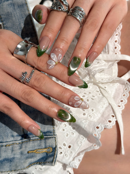 Forêt Perlée portée sur les mains, faux ongles artisanaux vert cat eye avec fleur 3D nacrée, faits main par NAILMUSEE
