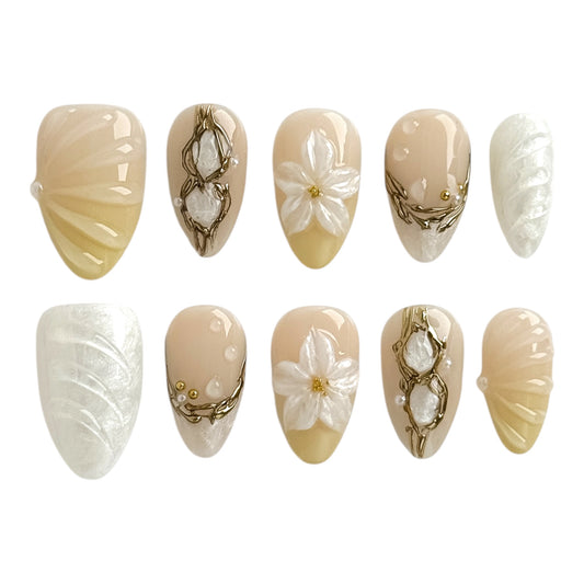 Ivory Relique handmade press-on nails by NailMusee featuring 3D floral details, pearl shell textures, and vintage gold accents in soft ivory nude tones.