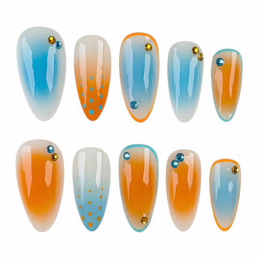 Faux ongles bleu et orange en dégradé avec finition brillante effet gel