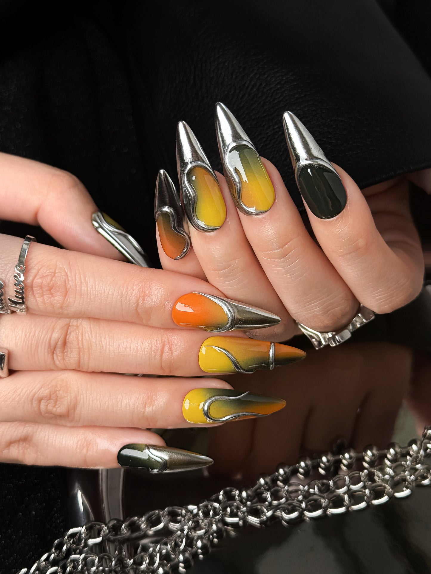 Futuristic Brazil-inspired stiletto press-on nails with metallic chrome accents and glossy gradient finish by NailMusee